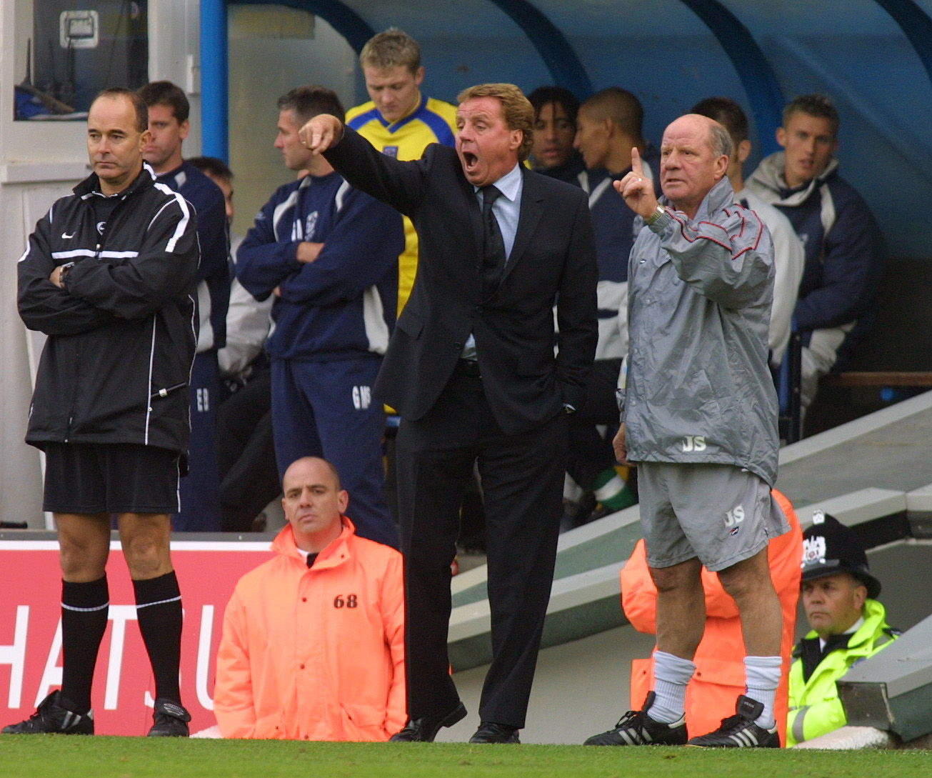 Portsmouth manager Harry Redknapp [C] and Assistant manager Jim Smith (R) shout orders from the touchline