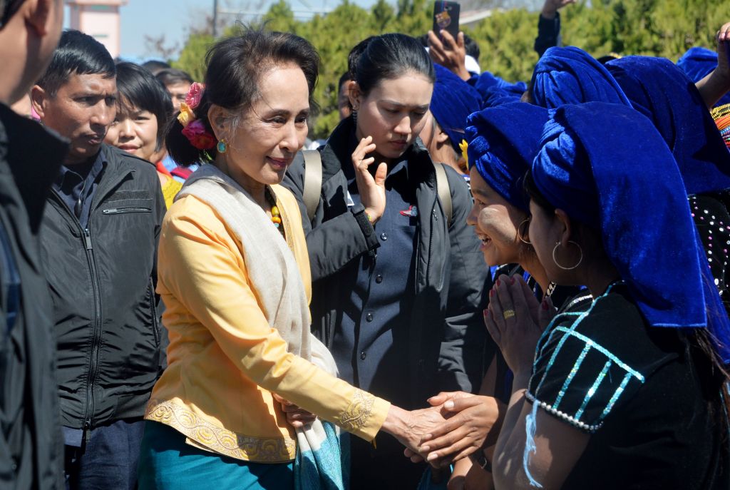 Myanmar's State Counsellor Aung San Suu Kyi (C) shakes hands with ethnic women after her trip to Shan State at the Hehoe airport on February 13, 2020. (Photo by Thet Aung / AFP) (Photo by THET AUNG/AFP via Getty Images)