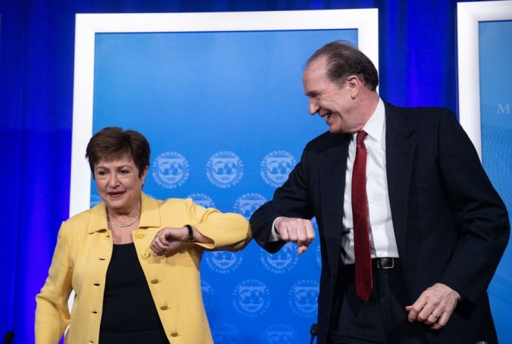 IMF Managing Director Kristalina Georgieva and World Bank Group President David Malpass bump elbows at the end of a joint press briefing on COVID-19 in Washington, DC, on March 4, 2020.