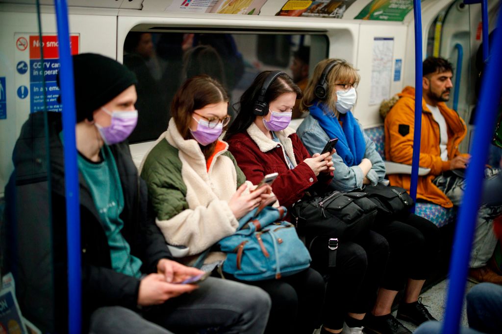 Commuters wear masks as a precaution whilst travelling on a London Underground train amid the coronavirus outbreak