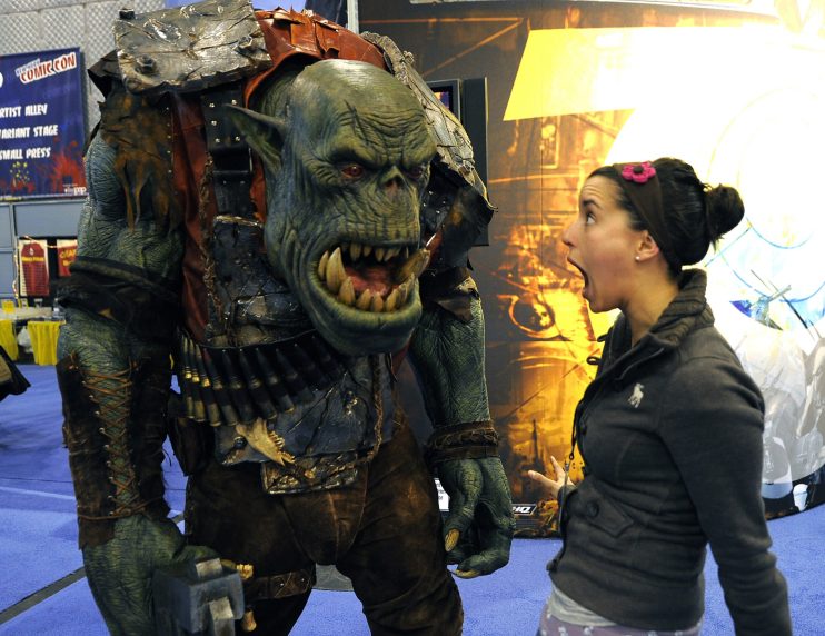 A Convention goer stands next to Ork fro