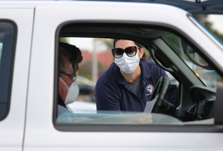 People Line Up For Unemployment Applications In Hialeah, FL During COVID-19 Crisis as jobless claims soar