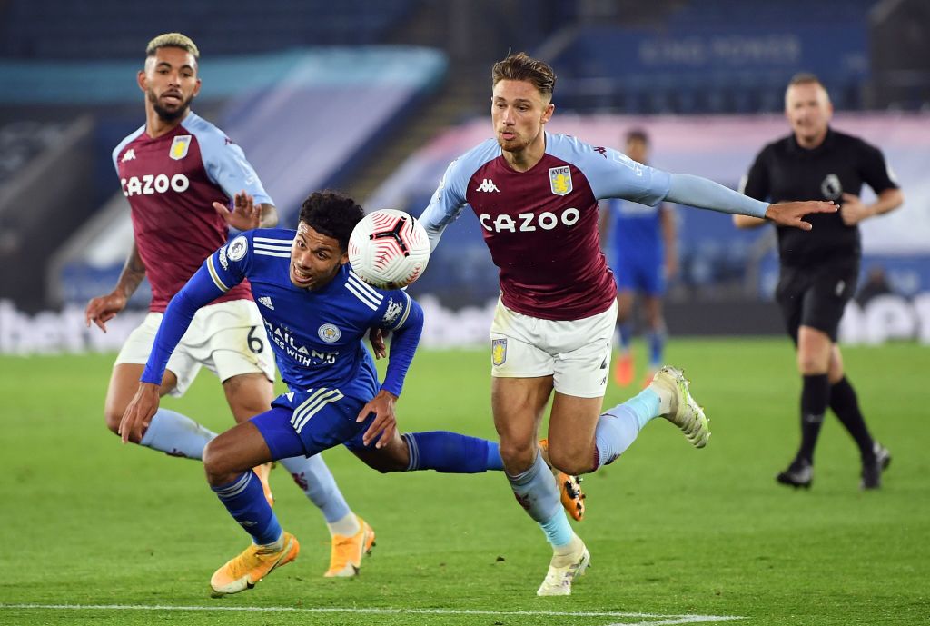 Leicester's James Justin challenges for the ball with Aston Villa's Matty Cash