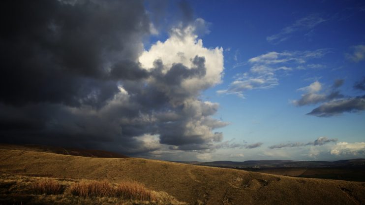 blue sky behind storm clouds in countryside