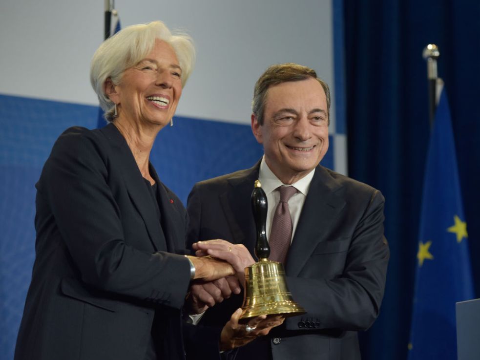 Mario Draghi, former president of the European Central Bank (ECB) hands a ceremonial bell to Christine Lagarde, his replacement, in 2019. (Photo by Bernd Kammerer - Pool / Getty Images)