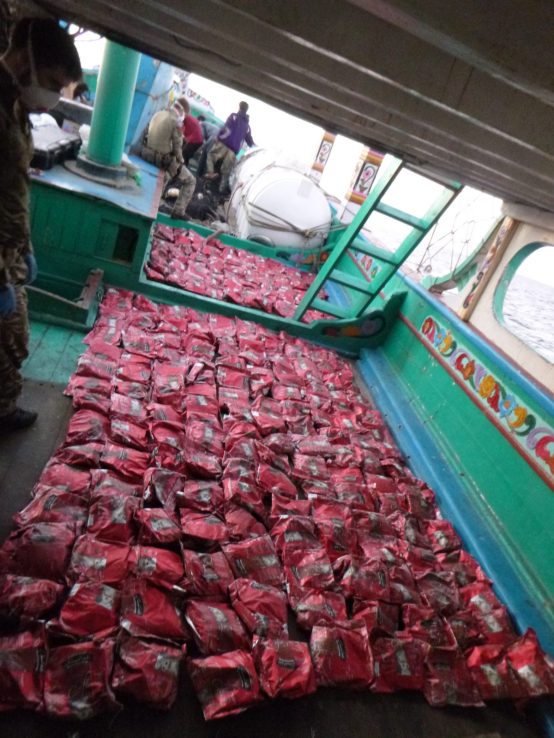Royal Marines boarding team from HMS Momtrose inspect sacks of suspected heroin found onboard a suspicious dhow.
