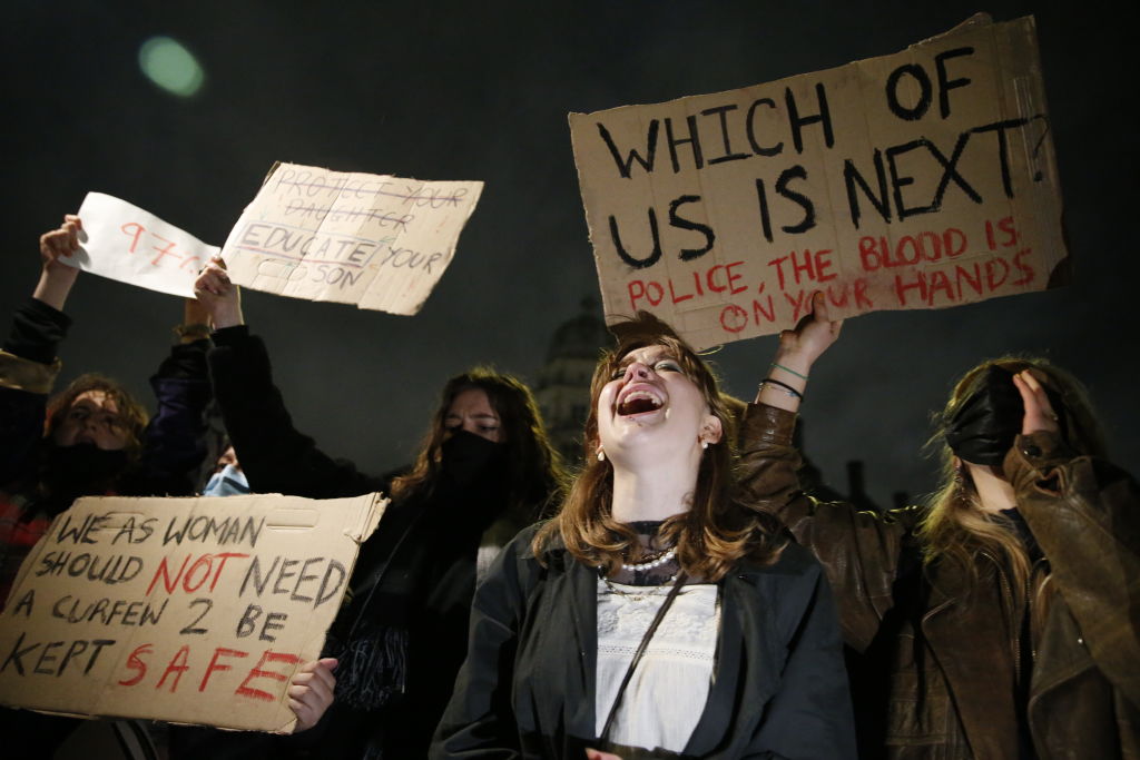 LONDON, ENGLAND - MARCH 14: Protesters hold signs and shout during a protest criticising the actions of the police at last night's vigil on Parliament Square on March 14, 2021 in London, England. Photo by Hollie Adams/Getty Images)