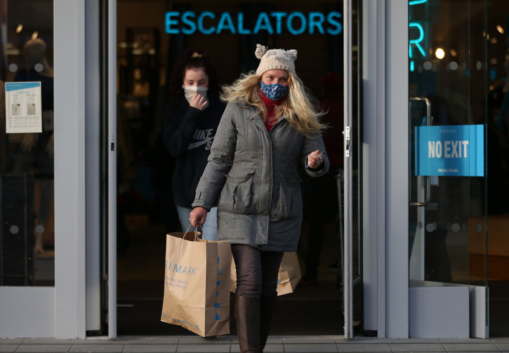 TRURO, ENGLAND - APRIL 12: A woman leaves Primark with bags as shops reopen after coronavirus restrictions ease on April 12, 2021 in Truro, England. England has taken a significant step in easing its lockdown restrictions, with non-essential retail, beauty services, gyms and outdoor entertainment venues among the businesses given the green light to re-open with coronavirus precautions in place. Pubs and restaurants are also allowed open their outdoor areas, with no requirements for patrons to order food when buying alcoholic drinks. (Photo by Cameron Smith/Getty Images)