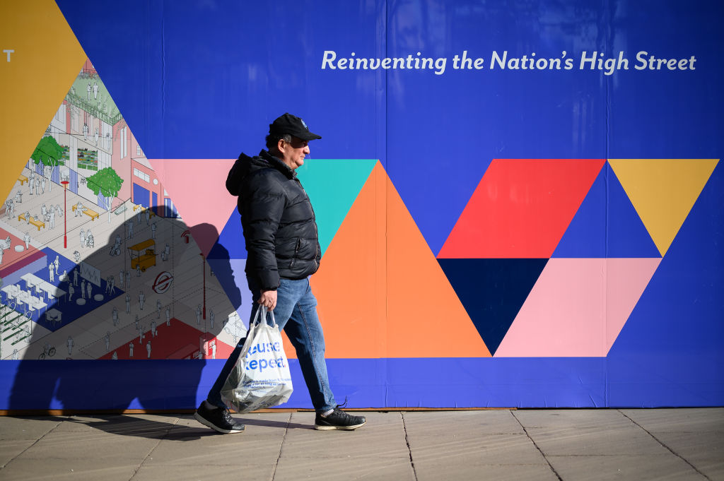 LONDON, ENGLAND - APRIL 19: A sign reading "Reinventing the Nation's Hugh Street", advertising the development of a retail property is seen as commuters and shoppers walk along Oxford Street on April 19, 2021 in London, England. Photo by Leon Neal/Getty Images)