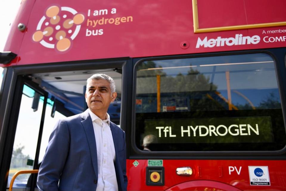 Mayor of London Sadiq Khan stands besides new hydrogen bus