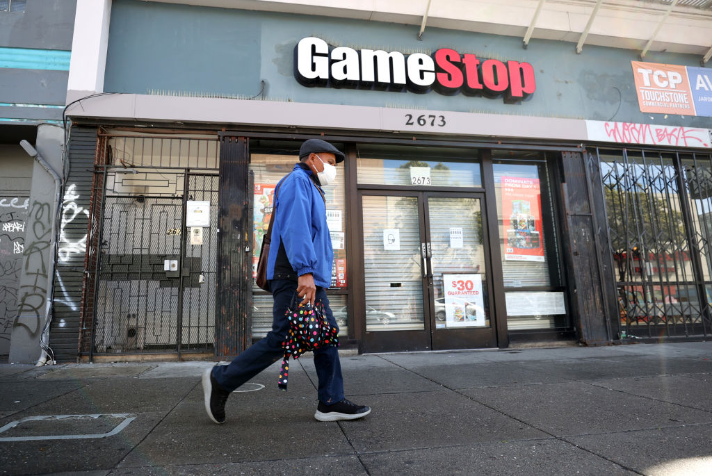 A pedestrian walks by a GameStop store in San Francisco. (Photo by Justin Sullivan/Getty Images)