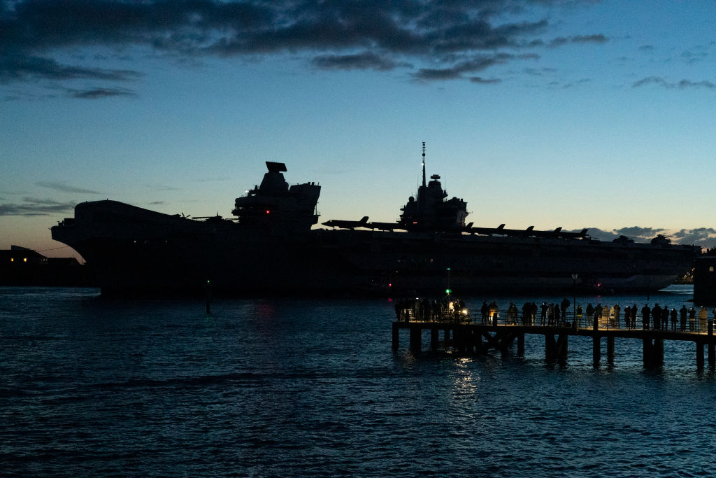 British aircraft carrier HMS Queen Elizabeth slips out of Portsmouth Harbour at dusk  on May 22, 2021 in Southsea, England. (Photo by Chris Eades/Getty Images)