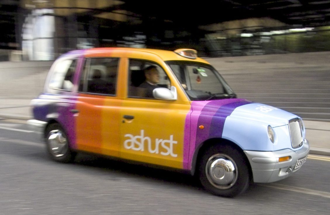 A London taxi custom painted with the name of international law firm Ashurst (Photo by Adrian Brown/Bloomberg via Getty Images)