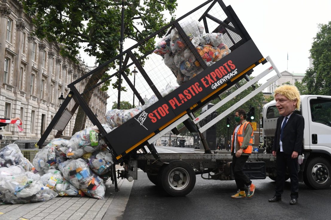 Greenpeace activists dump 625kg of plastic waste at the Prime Minister’s gate with a tipper truck reading ‘Stop plastic exports’. 
(Chris J Ratcliffe / Greenpeace)