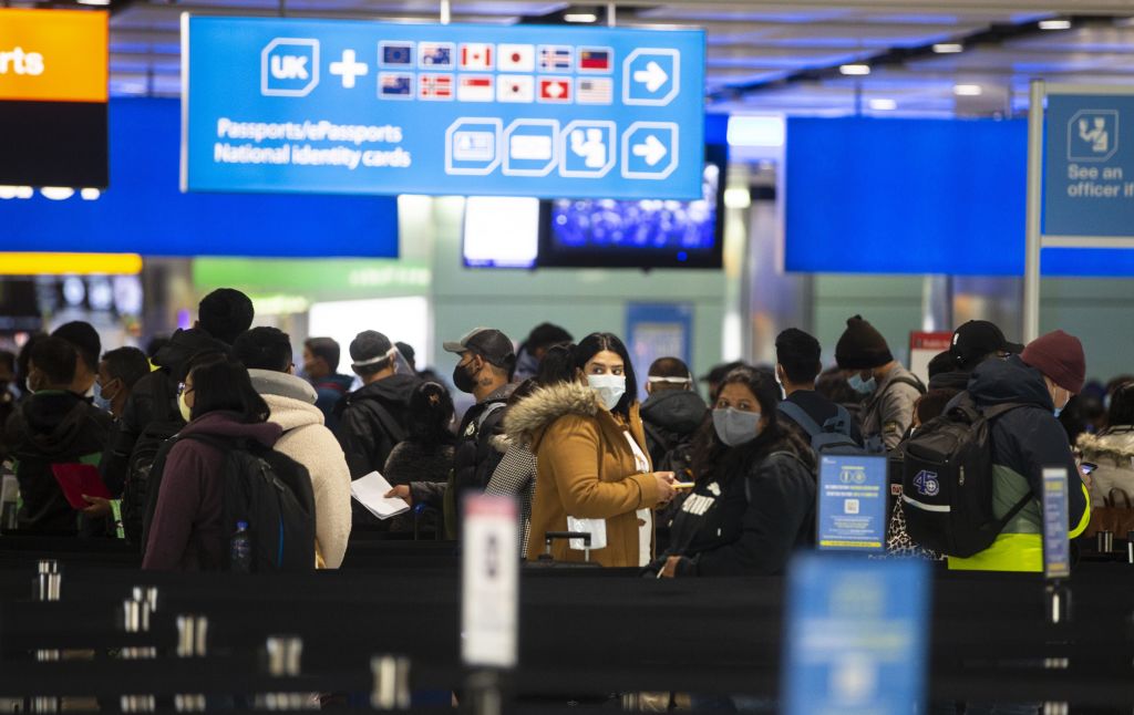 People queue at UK border control at Terminal 2 at Heathrow Airport. (Photo by Ian Vogler - Pool/Getty Images)