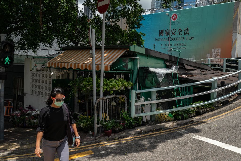 HONG KONG, CHINA - JULY 16: A pedestrians walk past a government-sponsored advertisement promoting a new national security law on July 16, 2020 in Hong Kong, China. (Photo by Anthony Kwan/Getty Images)