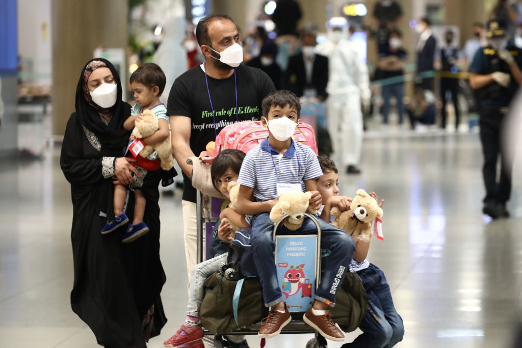 Evacuees from Afghanistan arrive at Incheon International Airport, South Korea on August 26 as thousands attempt to flee the war-torn country (Photo by Chung Sung-Jun/Getty Images)