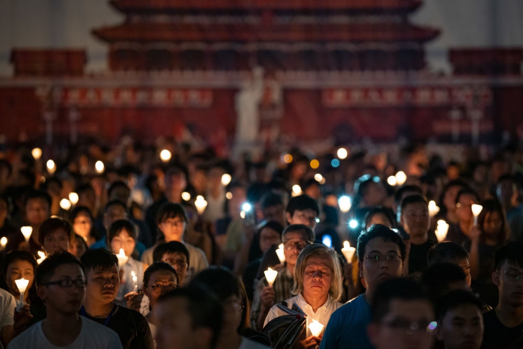 HONG KONG - JUNE 04: People hold candles as they take part in a candlelight vigil at Victoria Park on June 4, 2019 in Hong Kong, China. As many as 180,000 people were expected to attend a candlelight vigil in Hong Kong on Tuesday on the 30th anniversary of the Tiananmen Square massacre.  (Photo by Anthony Kwan/Getty Images)