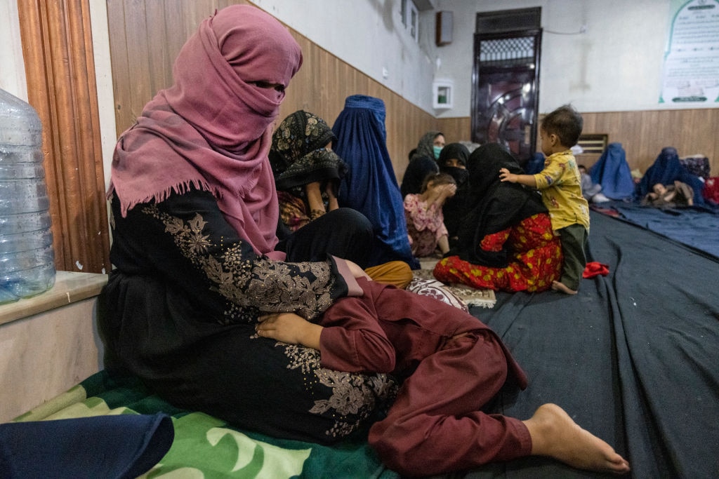 Displaced Afghan women and children from Kunduz are seen at a mosque that is sheltering them in Kabul, Afghanistan. Enamullah Samangani, a member of the Taliban's cultural commission, has made vague remarks insinuating that women should join the group's new government.  (Photo by Paula Bronstein /Getty Images)