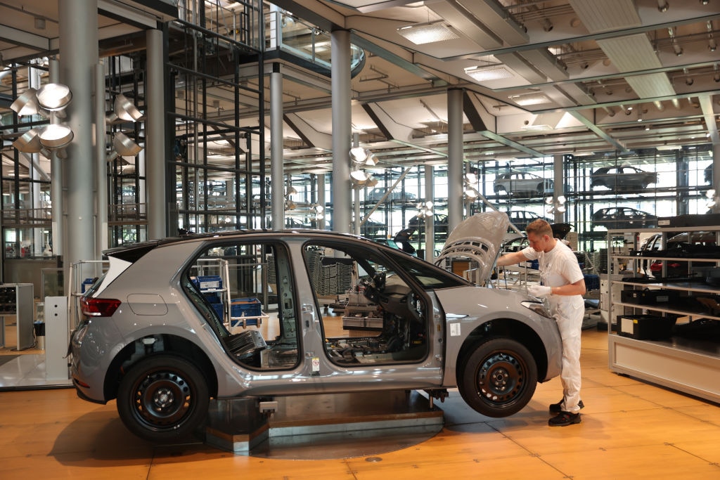 A worker assembles a Volkswagen ID.3 electric car at the "Gläserne Manufaktur" ("Glass Manufactory") production facility on June 08, 2021 in Dresden, Germany. Production at the company is being affected by the world's ongoing semiconductor chip shortage (Photo by Sean Gallup/Getty Images)