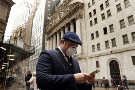 Big Tech earnings season is back, with a keen focus on cloud business, AI, and capex changes amid a challenging year on Wall Street. FILE PHOTO: A man walks on Wall Street in New York, U.S.