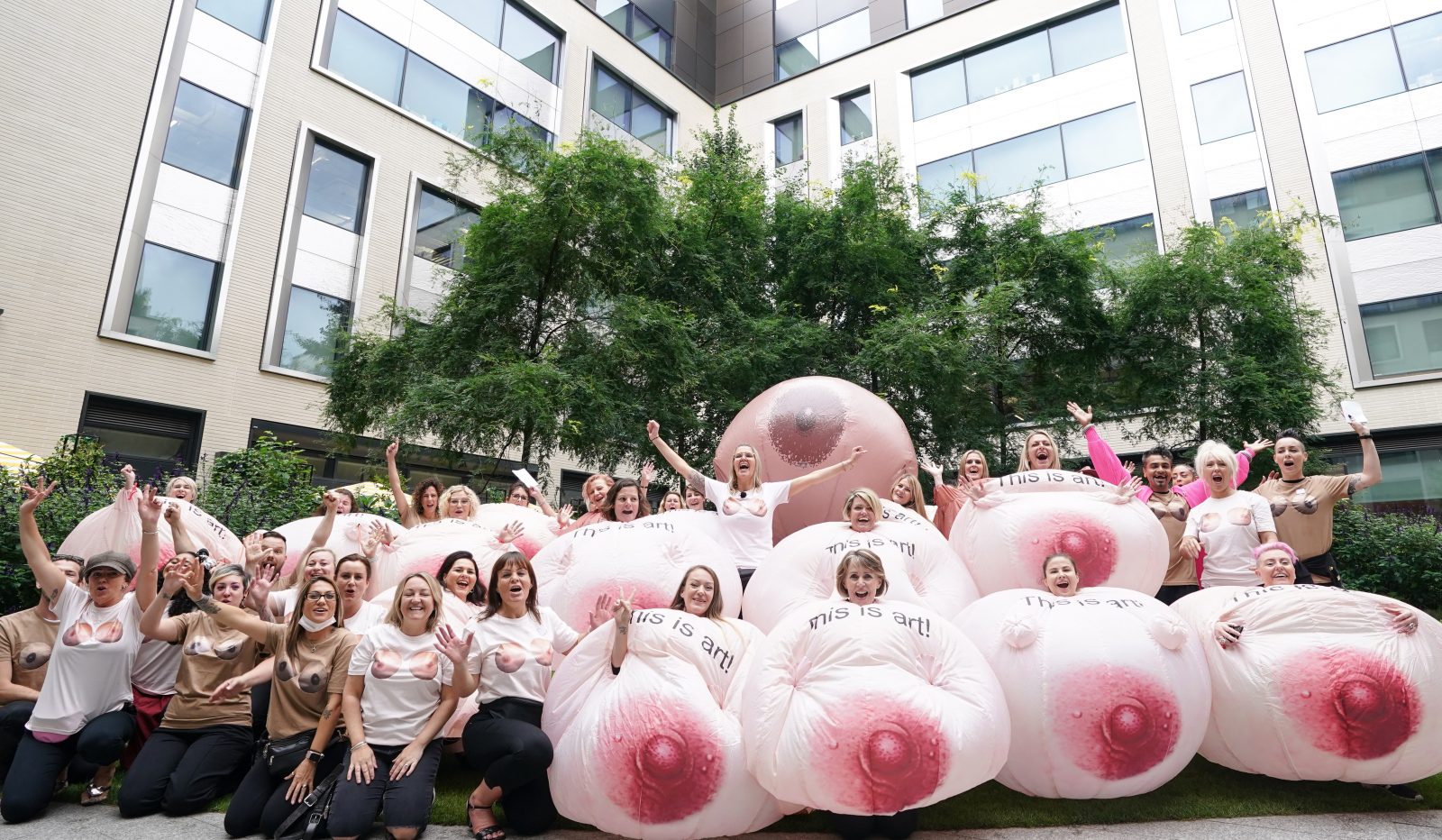 Protesters with inflatable breasts gather outside Facebook's