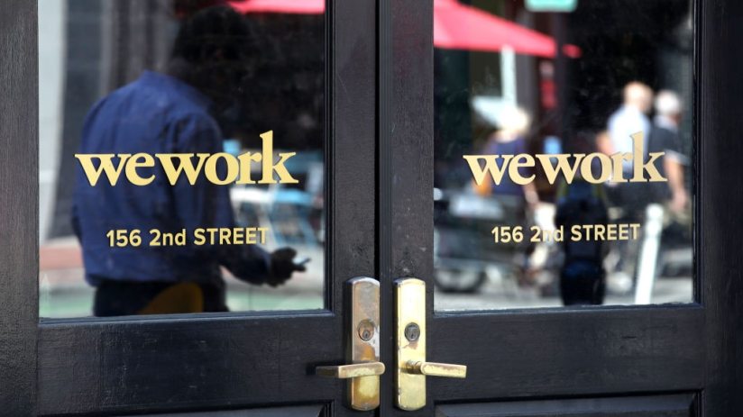 SAN FRANCISCO, CALIFORNIA - OCTOBER 07: A pedestrian walks by a WeWork office on October 07, 2019 in San Francisco, California. Days after withdrawing its registration for an initial public offering, WeWork also warned employees that the company could be set to lay off nearly 2,000 people, about 16 percent of its workforce. (Photo by Justin Sullivan/Getty Images)