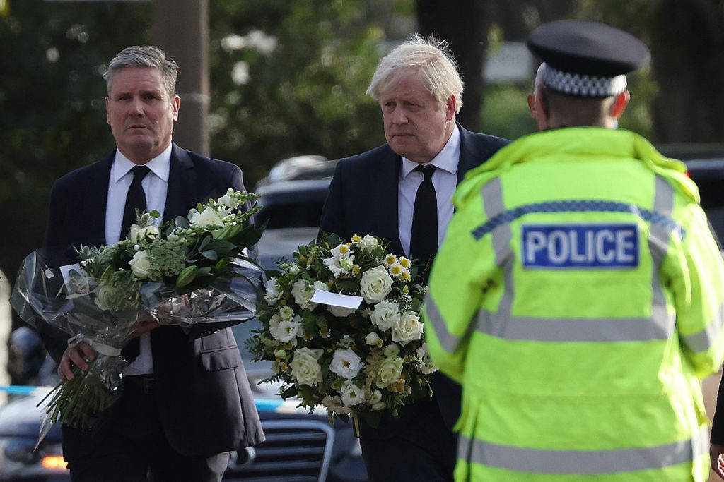 LEIGH-ON-SEA, ENGLAND - OCTOBER 16: (L-R) Keir Starmer, leader of the Labour Party, and Boris Johnson, Prime Minister, lay flowers at Belfairs Methodist Church on October 16, 2021 in Leigh-on-Sea, United Kingdom. Counter-terrorism officers are investigating the murder of Sir David Amess, the Conservative MP for Southend West, who was stabbed to death during his constituency surgery yesterday around midday.  A man in his twenties was arrested at the scene.  (Photo by Hollie Adams/Getty Images)