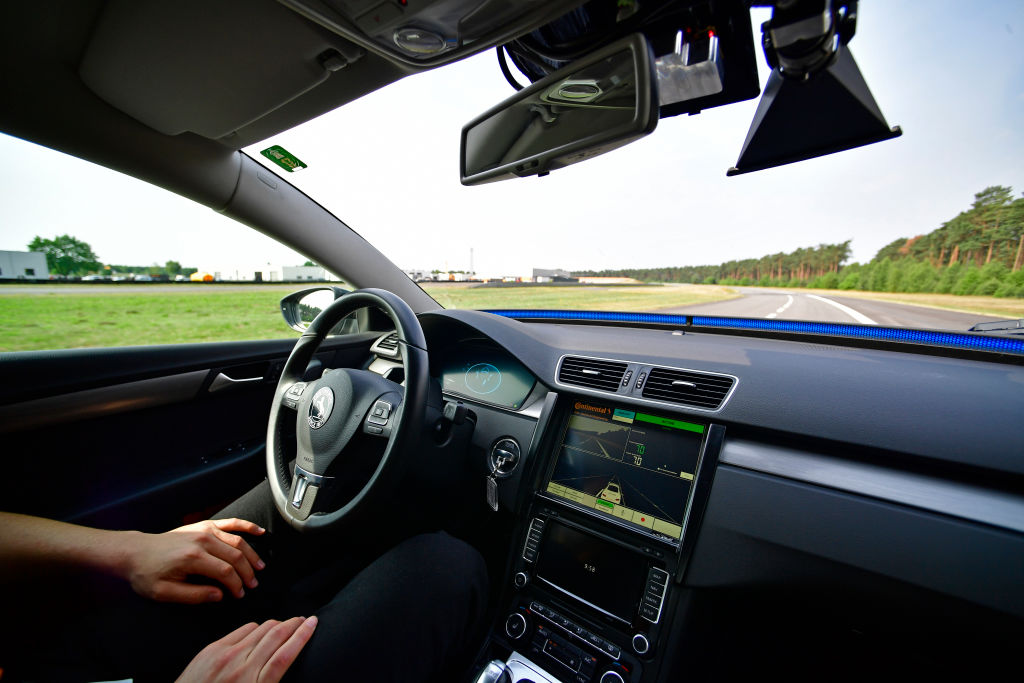 HANOVER, GERMANY - JUNE 20: A driver presents a Cruising Chauffeur, a hands free self-driving system designed for motorways during a media event by Continental to showcase new automotive technologies on June 20, 2017 in Hannover, Germany. The company presented new clean diesel technology, cable-less and other advances in electric car charging, smartphone technology for rental cars, driverless car advances and robotic taxi services. (Photo by Alexander Koerner/Getty Images)