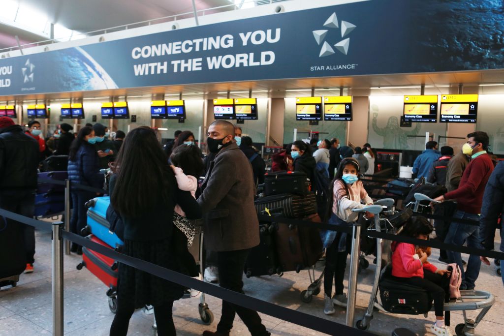Travellers queue to check in at Terminal 3 at Heathrow Airport. 