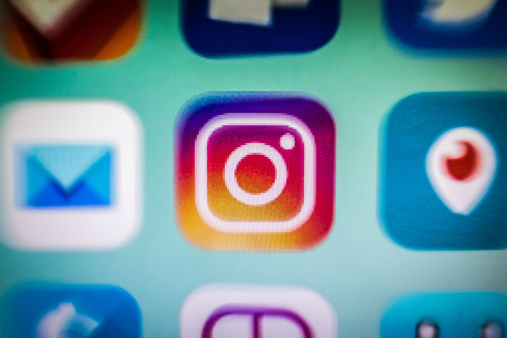 In this photo illustration, an Instagram app icon is
