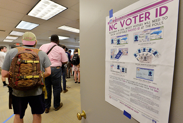 RALEIGH, NC - MARCH 15:  North Carolina State University students wait in line to vote in the primaries at Pullen Community Center on March 15, 2016 in Raleigh, North Carolina. The North Carolina primaries is the state's first use of the voter ID law, which excludes student ID cards. Wake County was among the highest use of provisional ballots, where those voters had home addresses on or near campuses. The Board of Elections will review voter's reasonable impediment form submitted with their provisional ballots to determine if their vote counts. The state's voter ID law is still being argued in federal court. (Photo by Sara D. Davis/Getty Images )