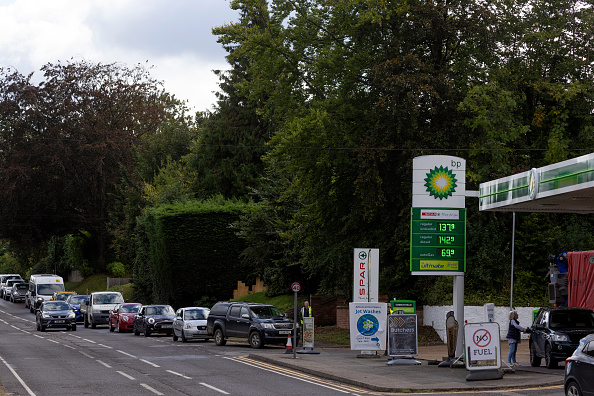 WEST MALLING, UNITED KINGDOM - OCTOBER 05: People queue for fuel at a BP station on October 05, 2021 in West Malling, United Kingdom. The Petrol Retailers Association (PRA), which represents almost 5,500 of the UK's 8,000 filling stations, said that around 20 percent of forecourts in London and the South East were out of fuel yesterday.  (Photo by Dan Kitwood/Getty Images)
