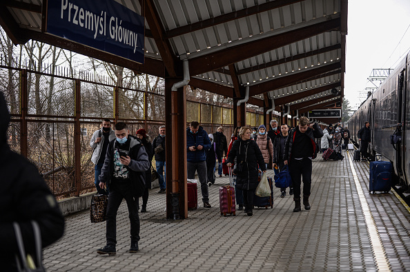 People carry suitcases as they exit a train arriving from Kiev at Przemysl main train station in Przemysl, Poland. (Photo by Omar Marques/Getty Images)