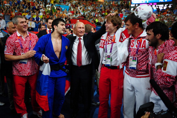 LONDON, ENGLAND - AUGUST 02:  Russian President Vladimir Putin (C) celebrates Tagir Khaibulaev of Russia's gold medal in the Men's -100 kg Judo on Day 6 of the London 2012 Olympic Games at ExCeL on August 2, 2012 in London, England.  (Photo by Laurence Griffiths/Getty Images)
