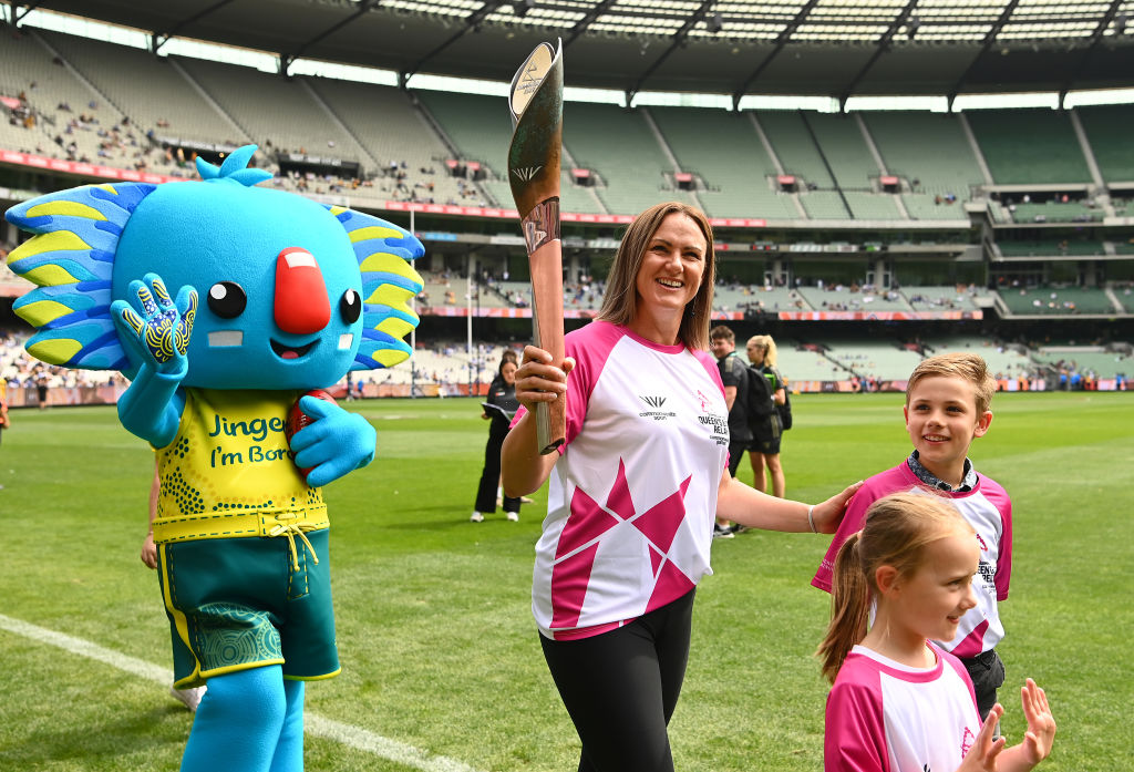 MELBOURNE, AUSTRALIA - MARCH 20: Sharelle McMahon takes part in the Commonwealth Games baton relay before the round one AFL match between the Hawthorn Hawks and the North Melbourne Kangaroos at Melbourne Cricket Ground on March 20, 2022 in Melbourne, Australia. (Photo by Quinn Rooney/Getty Images)