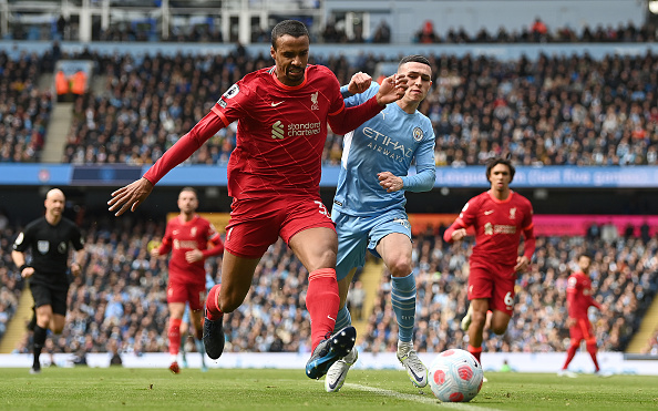 MANCHESTER, ENGLAND - APRIL 10: Joel Matip of Liverpool battles for possession with Phil Foden of Manchester City during the Premier League match between Manchester City and Liverpool at Etihad Stadium on April 10, 2022 in Manchester, England. (Photo by Shaun Botterill/Getty Images)