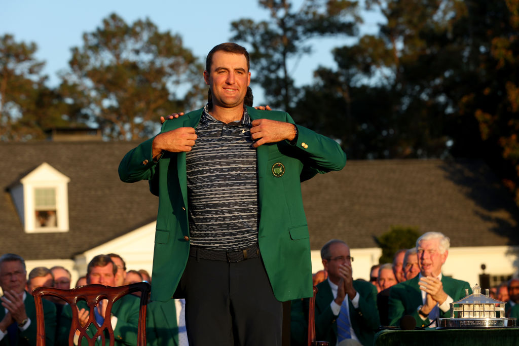 AUGUSTA, GEORGIA - APRIL 10: Scottie Scheffler is awarded the Green Jacket by 2021 Masters champion Hideki Matsuyama of Japan during the Green Jacket Ceremony after he won the Masters at Augusta National Golf Club on April 10, 2022 in Augusta, Georgia. (Photo by Andrew Redington/Getty Images)
