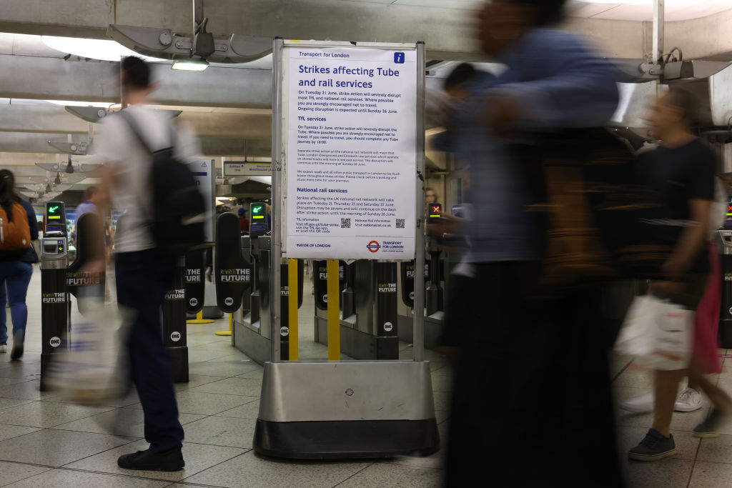 LONDON, ENGLAND - JUNE 18: Pedestrians walk past a Transport for London notice inside Westminster Tube station on June 18, 2022 in London, England. Tube strikes are set to disrupt Transport for London (TfL) and national rail services on Tuesday 21st of June. (Photo by Hollie Adams/Getty Images)