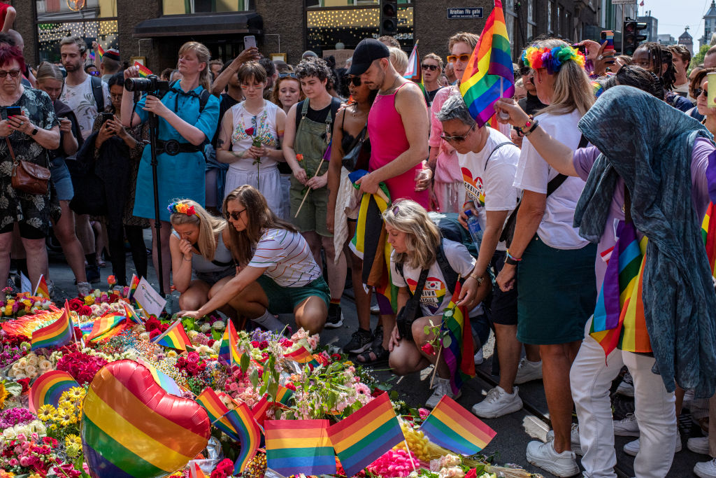 OSLO, NORWAY - JUNE 25: Flowers and rainbow flags are left along the street near a restaurant where two people were injured and at least 10 were injured when a man opened fire early Saturday morning near a popular gay club in the city's downton on June 25, 2022 in Oslo, Norway.  The incident happened hours before the annual Oslo gay pride parade. Police said they are investigating the shooting as a terrorist attack, and the organizers of the parade said they had canceled the event on the advice of authorities. (Photo Rodrigo Freitas/Getty Images)
