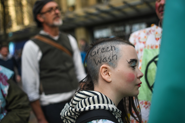 GLASGOW, SCOTLAND - NOVEMBER 03: A protester is seen with Green Wash written on her head during an Extinction Rebellion protest on November 3, 2021 in Glasgow, United Kingdom. As World Leaders meet to discuss climate change at the COP26 Summit, many climate action groups have taken to the streets to protest for real progress to be made by governments to reduce carbon emissions, clean up the oceans, reduce fossil fuel use and other issues relating to global heating. (Photo by Peter Summers/Getty Images)