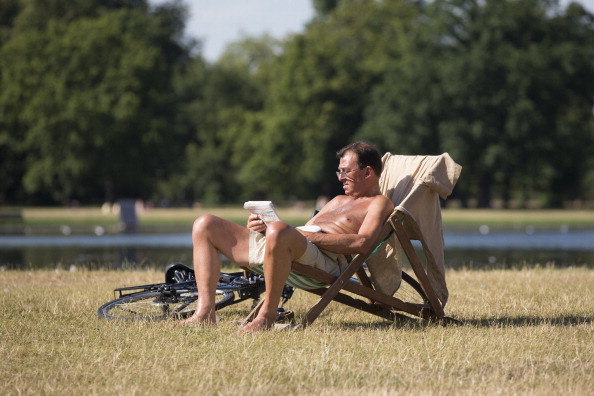 LONDON, ENGLAND - JULY 18:  A man relaxes in the warm weather in Hyde Park on July 18, 2014 in London, England. The Met Office has issued a heatwave alert as temperatures soar to their highest of the year.  (Photo by Oli Scarff/Getty Images)