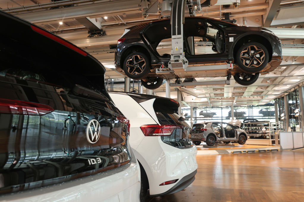 DRESDEN, GERMANY - JUNE 08: A ceiling conveyor carries a Volkswagen ID.3 electric car past others on the floor on the assembly line at the "Gläserne Manufaktur" ("Glass Manufactory") production facility on June 08, 2021 in Dresden, Germany. The Dresden plant is currently churning out 35 ID.3 cars per day. The ID.3 and ID.4 cars are also produced at VW's Zwickau plat located in the same region.  (Photo by Sean Gallup/Getty Images)