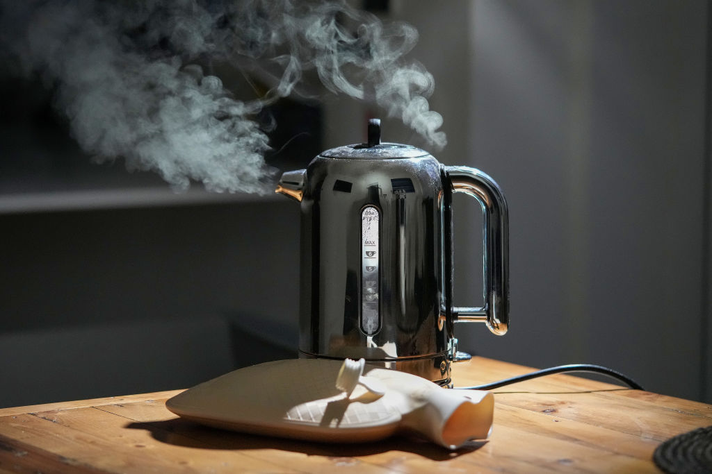   In this photo illustration a domestic electric kettle emits steam and vapour next to a hot water bottle on February 07, 2022 in Knutsford, United Kingdom.  global crisis in supply. (Photo illustration by Christopher Furlong/Getty Images)
