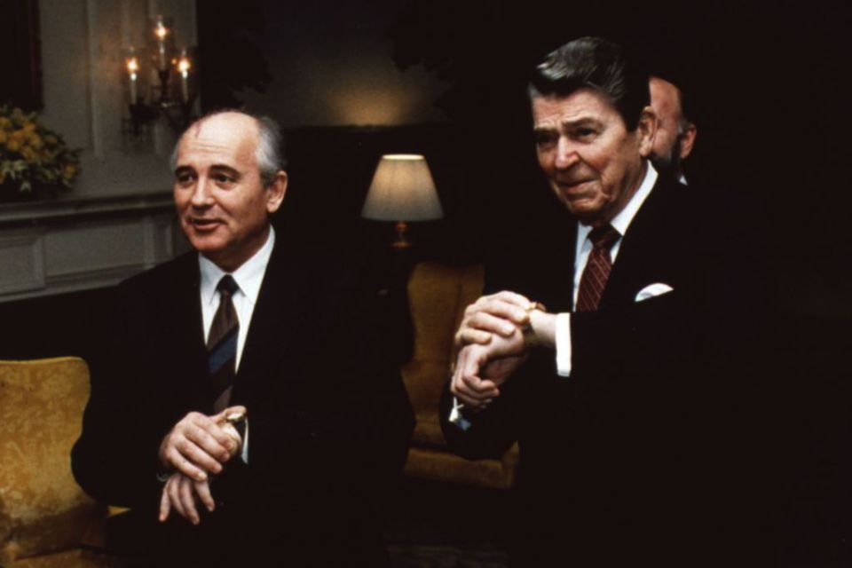 Ronald Reagan, the 40th President of the United States, and Soviet leader Mikhail Gorbachev (right) synchronize their watches.   (Photo by MPI/Getty Images)