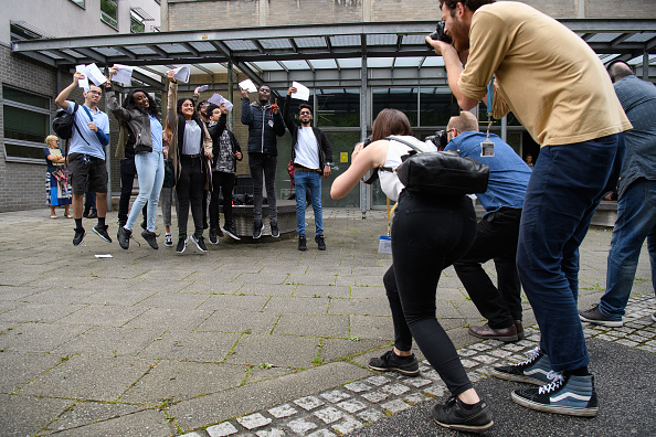 LONDON, ENGLAND - AUGUST 17:  Students jump into the air for photographers after receiving their A level results at City and Islington College on August 17, 2017 in London, England. The number of students receiving the highest grades of A and A* grades has increased for the first time in six years.  (Photo by Leon Neal/Getty Images)