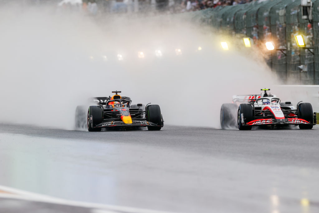 SUZUKA, JAPAN - OCTOBER 09: Max Verstappen of Red Bull Racing and The Netherlands overtakes Mick Schumacher of Germany and Haas  during the F1 Grand Prix of Japan at Suzuka International Racing Course on October 09, 2022 in Suzuka, Japan. (Photo by Peter Fox/Getty Images)