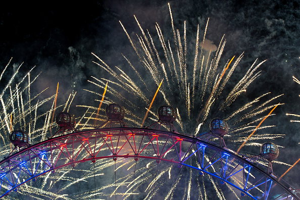 Fireworks light up the London Eye just after midnight in the centre of London  (Photo by Ben Pruchnie/Getty Images)