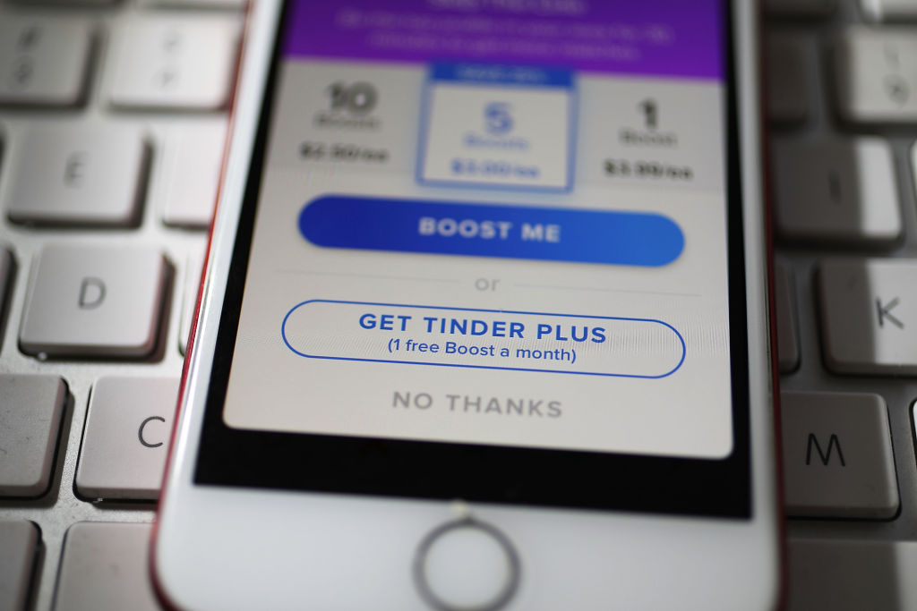 MIAMI, FL - AUGUST 14:  In this photo illustration, the dating app Tinder is seen on the screen of an iPhone on August 14, 2018 in Miami, Florida.  The co-founders of Tinder and eight other former and current executives of the dating app are suing the service's current owners for at least $2 billion.  (Photo illustration by Joe Raedle/Getty Images)