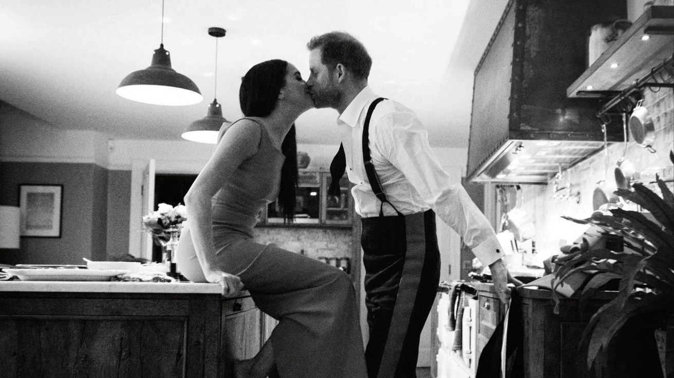 BLACK AND WHITE ONLY Undated handout photo issued by Netflix of the Duke and Duchess of Sussex kissing in a kitchen. The picture is part of a trailer for a new documentary called "Harry and Meghan" - the Sussexes' behind the scenes. The one minute trailer - which featured never before seen private photographs of the couple - was released on the second day of the Prince and Princess of Wales's high profile trip to the US. Issue date: Thursday December 1, 2022.